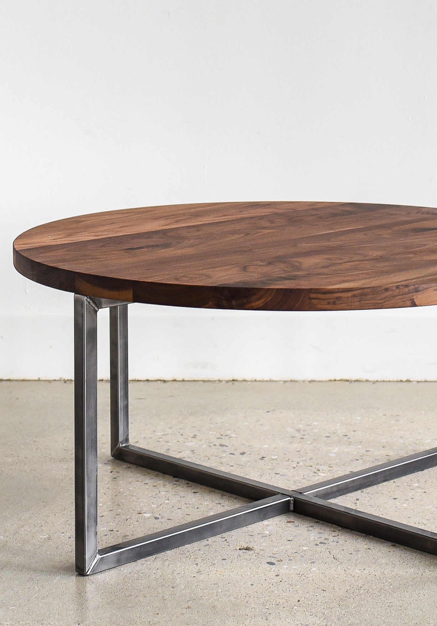 Circular wood coffee table in Reclaimed Oak / Clear & Blackened Metal 