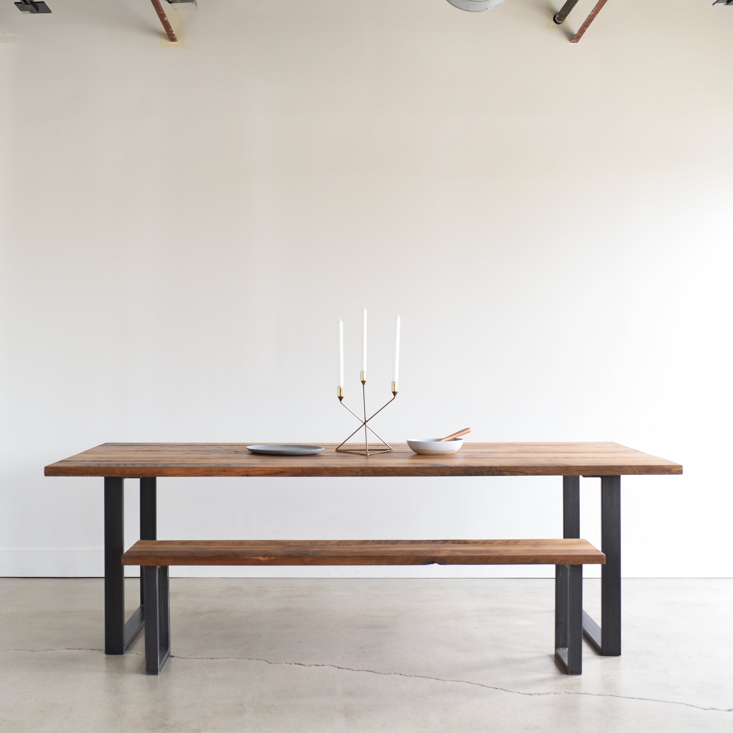 Industrial Modern Dining Table in Reclaimed Oak/ textured with Blackened Metal U-shaped Legs. Featured with our <a href=