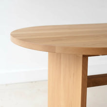 Close-up of white oak wood dining table showing the rounded tabletop edge.