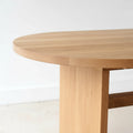 Close-up of white oak wood dining table showing the rounded tabletop edge.