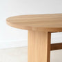 Close-up of white oak wood dining table showing the rounded tabletop edge.