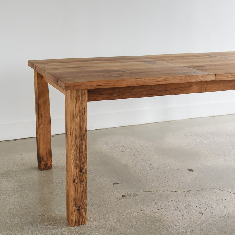 Farmhouse Extendable Dining Table Pictured In Reclaimed Oak Clear  - Post Leg Detail with leaf insert