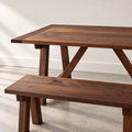 Farmhouse Trestle Dining Table Pictured In Walnut Clear Featured with our <a href="/products/trestle-wood-dining-bench">Trestle Wood Bench</a> in Walnut Clear