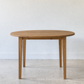 Round Tapered Leg Dining Table Pictured in Reclaimed Oak Clear