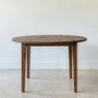 Round Tapered Leg Dining Table Pictured in Reclaimed Oak Walnut