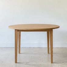 Round Tapered Leg Dining Table Pictured in White Oak Clear