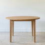 Round Tapered Leg Dining Table Pictured in White Oak Clear