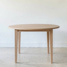 Round Tapered Leg Dining Table Pictured in White Oak Natural