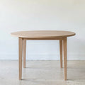 Round Tapered Leg Dining Table Pictured in White Oak Natural
