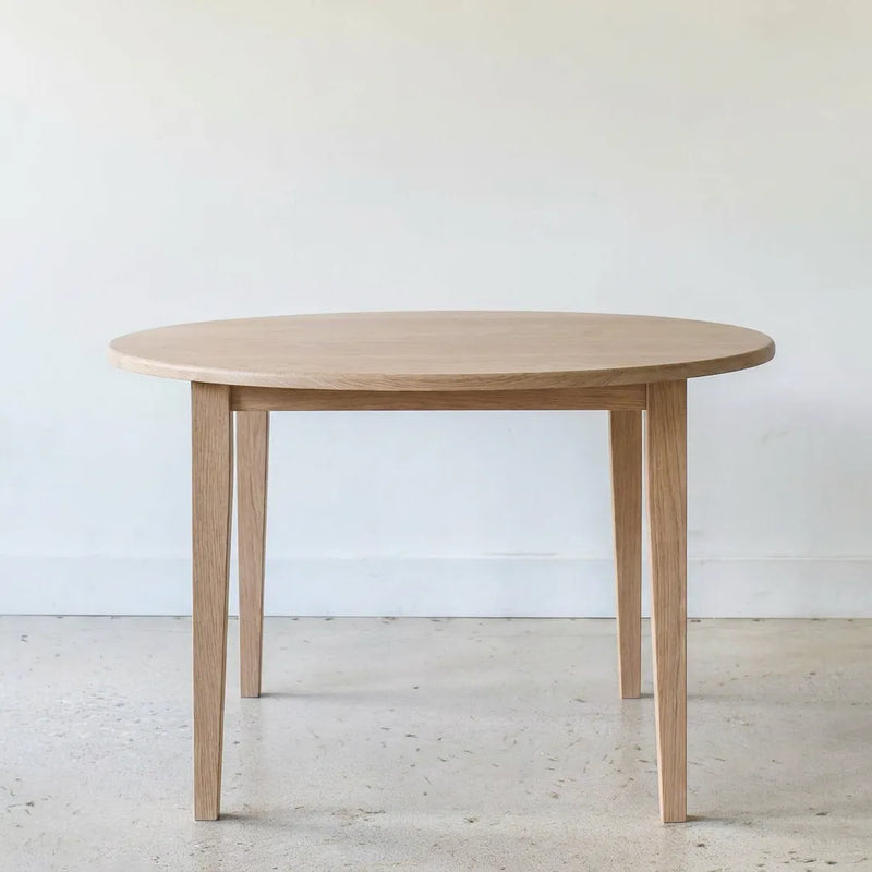 Round Tapered Leg Dining Table Pictured in White Oak Natural