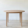 Round Tapered Leg Dining Table Pictured in White Oak Natural