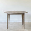 Round Tapered Leg Dining Table Pictured in White Oak Gray