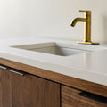 Showcasing the 1.5 inch thick soft white quartz vanity top with straight, slightly softened, rounded corner edge profile. 

