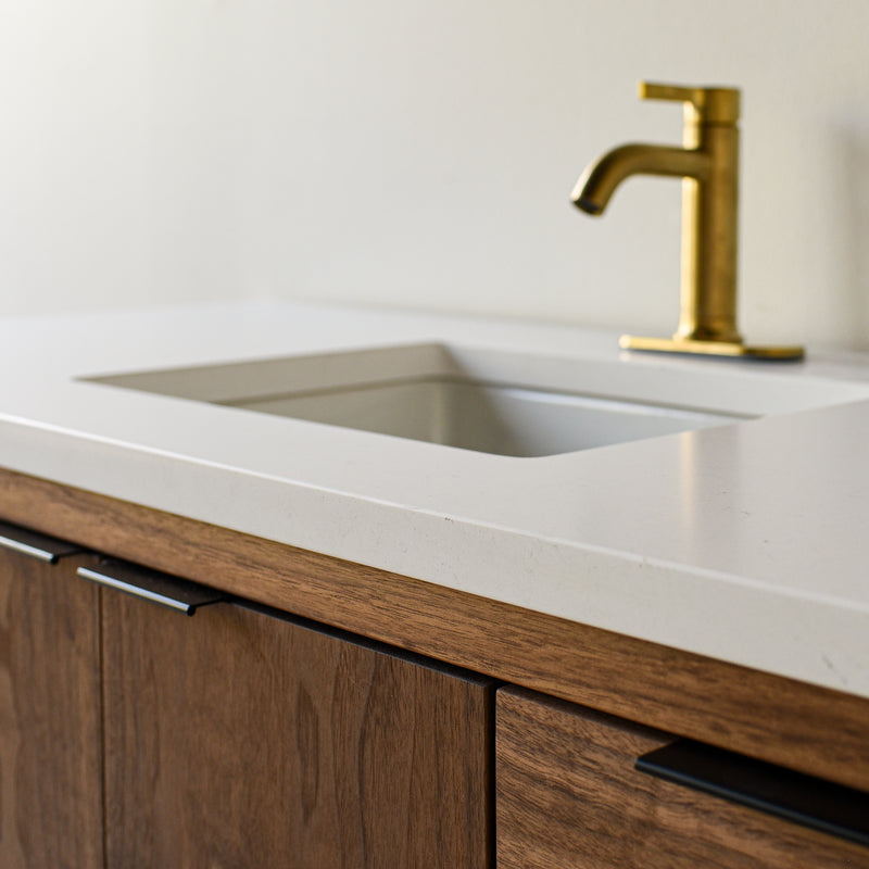 Showcasing the 1.5 inch thick soft white quartz vanity top with straight, slightly softened, rounded corner edge profile. 

