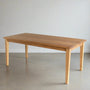 Slim Tapered Leg Dining Table Pictured in White Oak  Clear