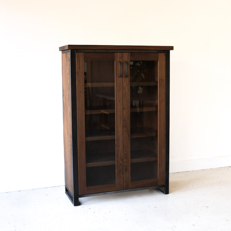 Wood + Glass Double Door Cabinet Pictured In Walnut Clear &amp; Blackened Metal
