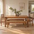 Our farmhouse solid wood dining table set in a bright, modern dining room with matching wood chairs and benches.