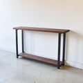Industrial Modern Console Table With Lower Shelf Pictured In Walnut Clear &amp; Blackened Metal