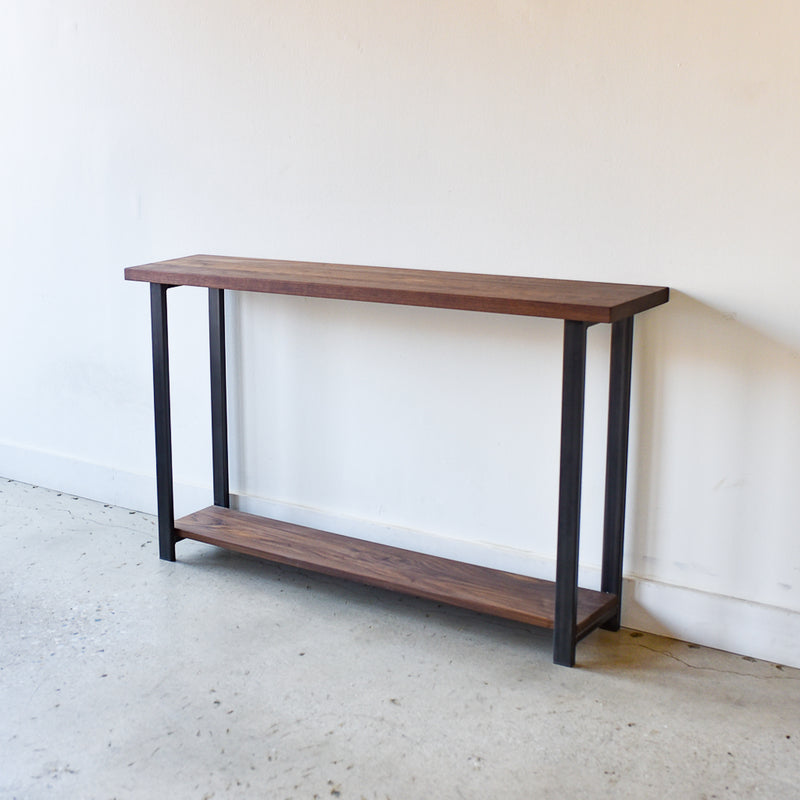 Industrial Modern Console Table With Lower Shelf Pictured In Walnut Clear &amp; Blackened Metal