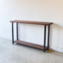 Industrial Modern Console Table With Lower Shelf Pictured In Walnut Clear &amp; Blackened Metal