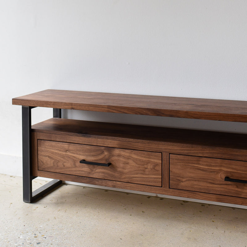 2-Drawer Modern Industrial Media Console Pictured in Walnut/ Clear &amp; Blackened Metal 