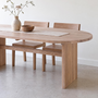 Modern Timber Oval Dining Table Pictured In White Oak Natural paired with wooden dining chairs.