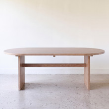 Straight on view of our Modern Timber Oval Dining Table Pictured In White Oak Natural.