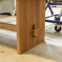 Close-up of wooden base and beam on our Modern Timber Frame Dining Table in our workshop.