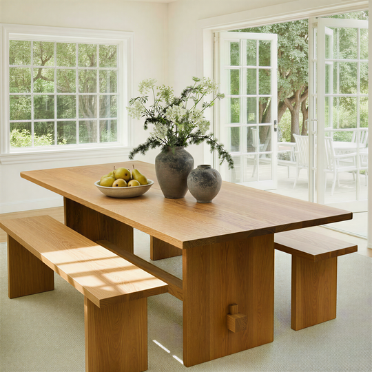 Modern Timber Frame Dining Table with benches in a bright room with large windows and a door. Pictured in White Oak Clear.