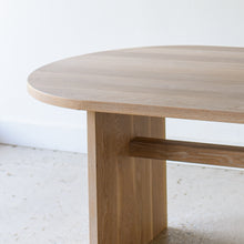 Detailing racetrack curve and hand sanded edges on our white oak natural tabletop. 