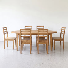 Oval Tapered Leg Dining Table  set with six matching tapered leg chairs.