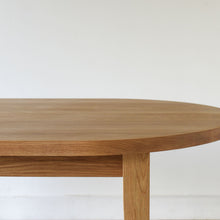 Close-up showing the apron and rounded edge of the tabletop in white oak clear.