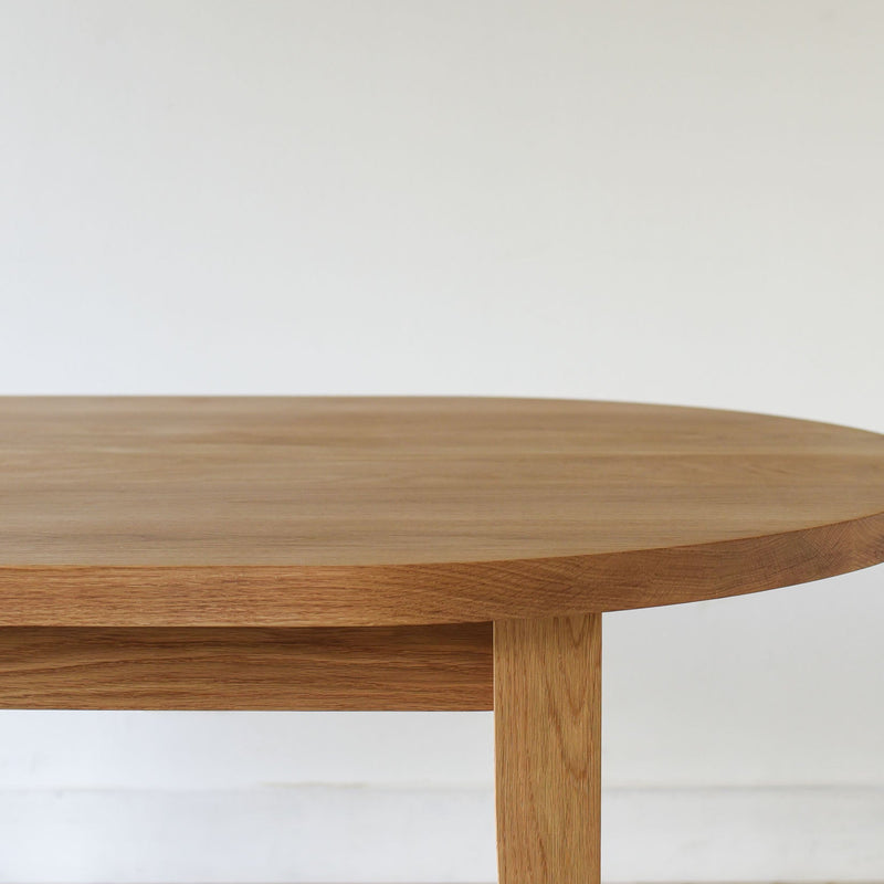 Close-up showing the apron and rounded edge of the tabletop in white oak clear.