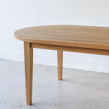 Showcasing the slim tapered leg on our white oak clear finish.