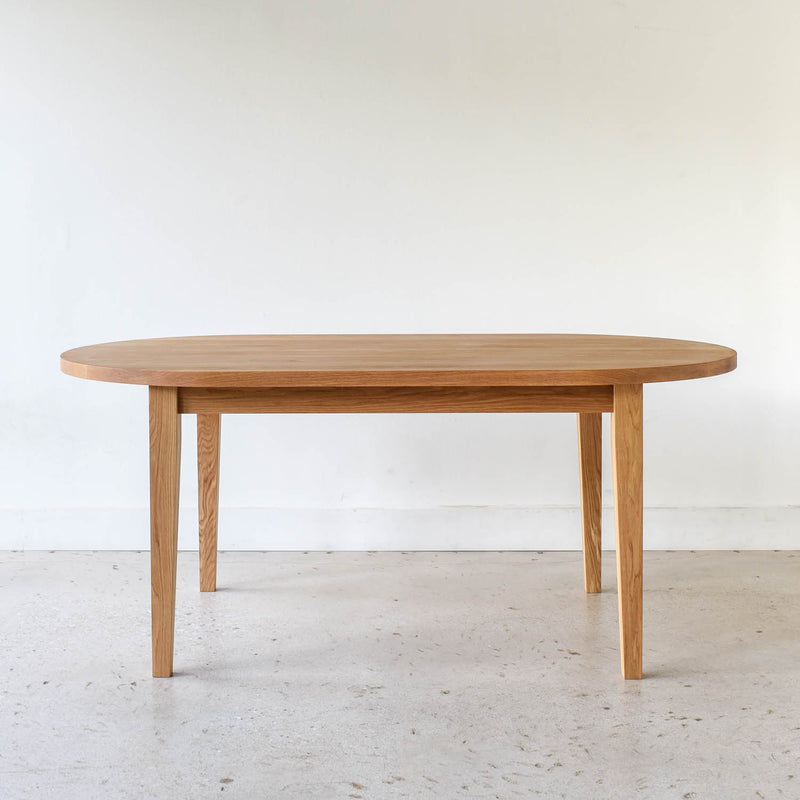 Oval Tapered Leg Dining Table Pictured in White Oak / Clear