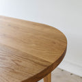 Oval Tapered Leg Dining Table Pictured in White Oak / Clear