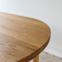 Oval Tapered Leg Dining Table Pictured in White Oak / Clear