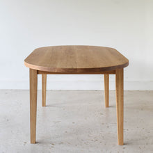 Oval Tapered Leg Dining Table Pictured in White Oak / Clear