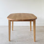 Oval Tapered Leg Dining Table Pictured in White Oak / Clear