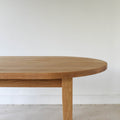 Oval Tapered Leg Dining Table Pictured in White Oak / Clear