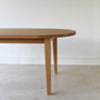 Oval Tapered Leg Dining Table Pictured in White Oak / Clear