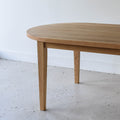 Oval Tapered Leg Dining Table Pictured in White Oak / Clear