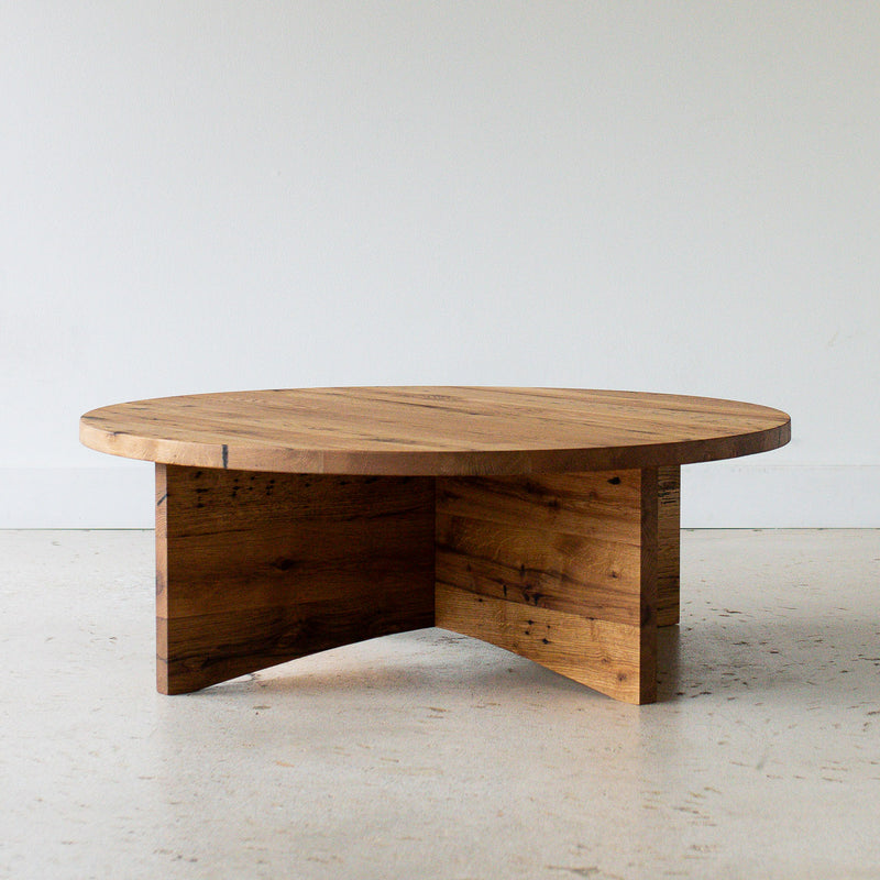 Sculptural Round Wood Coffee Table Pictured in Reclaimed Oak / Clear