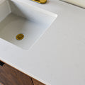 A close-up of soft white quartz countertop with subtle veining.
