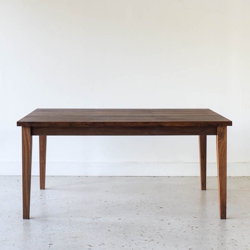 Extendable Slim Tapered Leg Dining Table Pictured in Walnut Clear