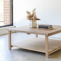 Square Modern Solid Wood Coffee Table With Lower Shelf Pictured in White Oak/ Natural