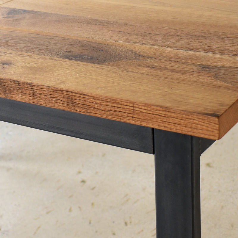 Close up of the blackened steel apron and legs on the Industrial Plank Extendable Dining Table in Reclaimed Oak Clear &amp; Blackened Metal Base