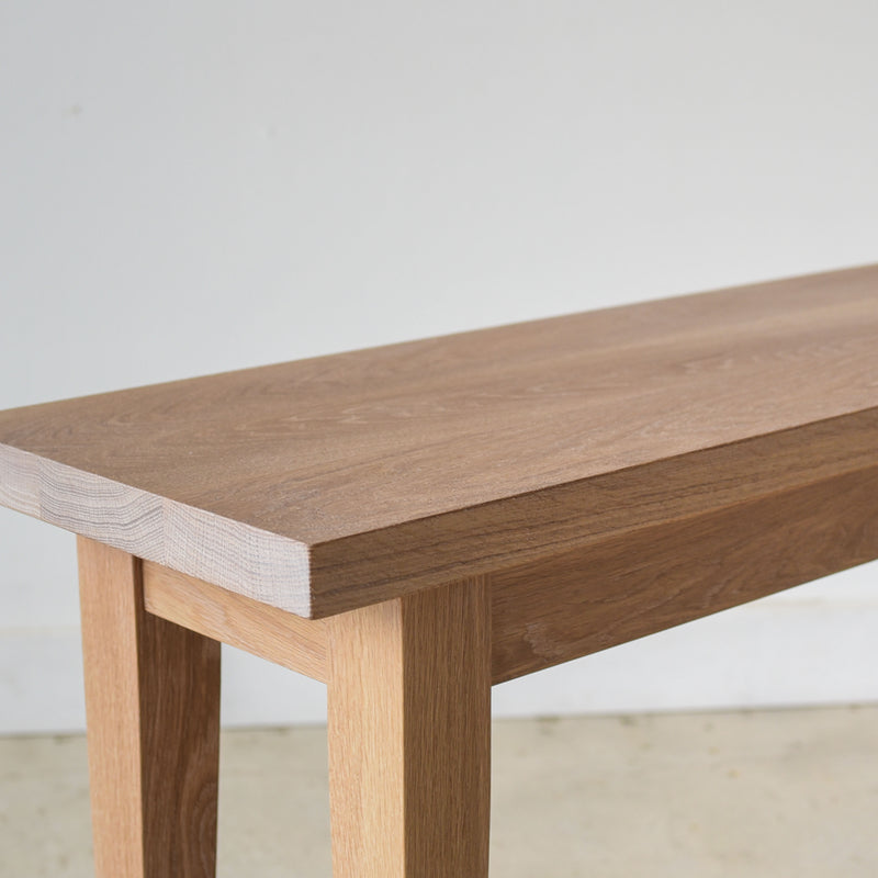 Tapered Leg Console Table With Hidden Drawer Pictured In White Oak Natural